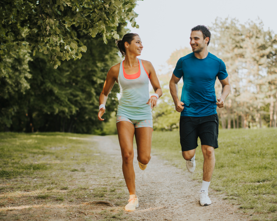 A serene city park at dawn, filled with soft, golden light. In the foreground, a well-maintained running path winds smoothly beneath lush green trees, inviting beginners to explore. Scattered on the path are a few amateur runners, dressed in bright, modest athletic clothing, appearing focused and content. In the middle ground, benches and informational signs guide runners, illustrating tips on safety and pacing. The background features a tranquil lake reflecting the clear sky, with gentle hills and more trees creating a peaceful atmosphere. The overall mood is encouraging and safe, embodying an inviting space for new runners to embrace their journey. Capture this scene with a wide-angle perspective to enhance the sense of openness and accessibility. A serene city park at dawn, filled with soft, golden light. In the foreground, a well-maintained running path winds smoothly beneath lush green trees, inviting beginners to explore. Scattered on the path are a few amateur runners, dressed in bright, modest athletic clothing, appearing focused and content. In the middle ground, benches and informational signs guide runners, illustrating tips on safety and pacing. The background features a tranquil lake reflecting the clear sky, with gentle hills and more trees creating a peaceful atmosphere. The overall mood is encouraging and safe, embodying an inviting space for new runners to embrace their journey. Capture this scene with a wide-angle perspective to enhance the sense of openness and accessibility.